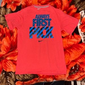 Red Nike tee “always first pick”